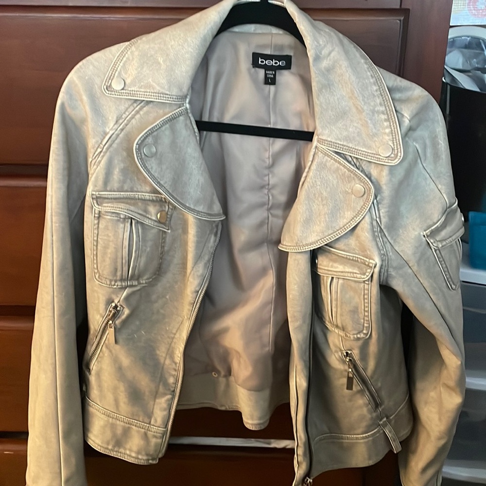 BeAutiful jacket runs small. Side zip. Zipper details on pockets.